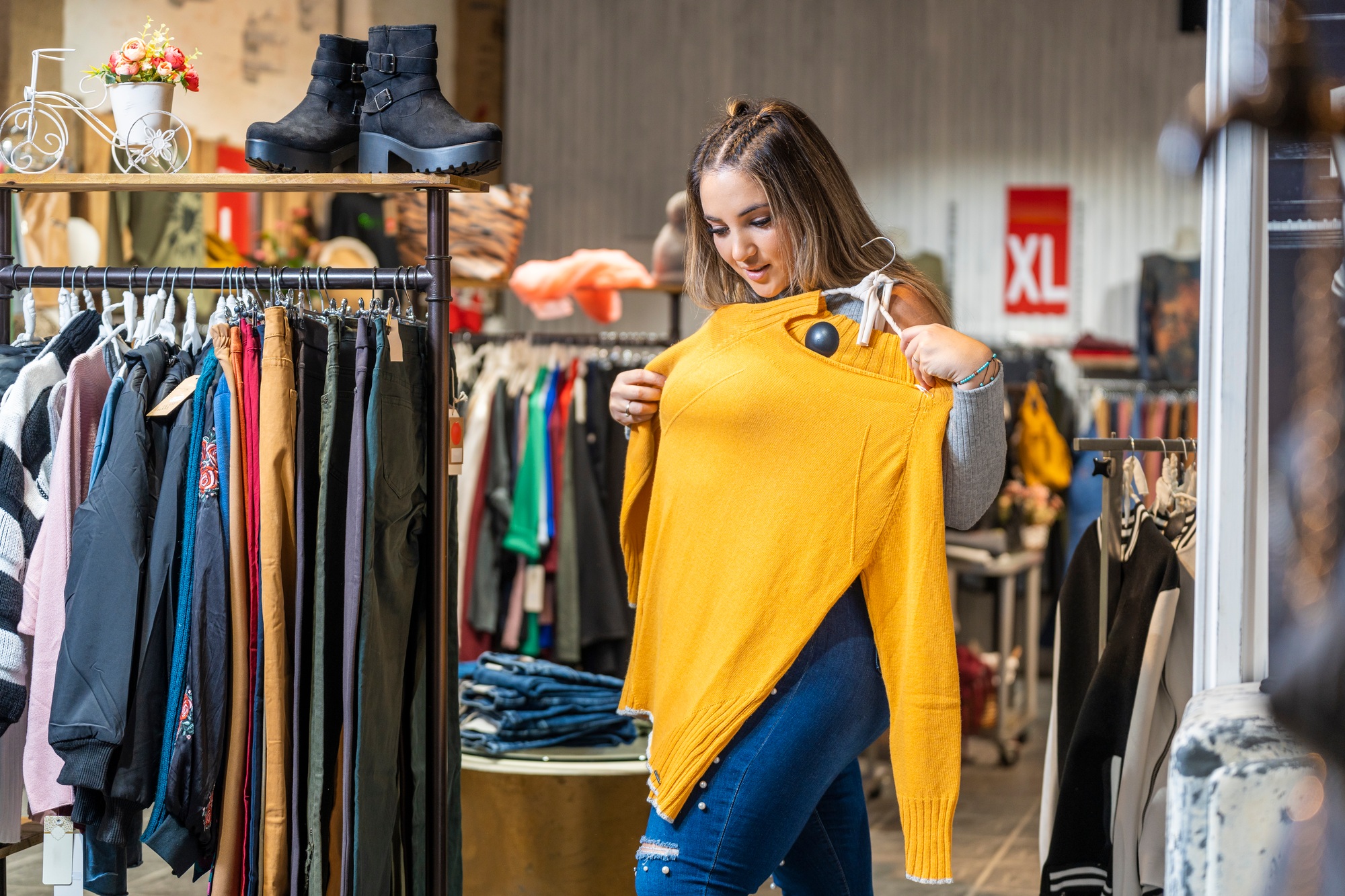 Overweight woman trying on clothes in a clothing store in the plus size section