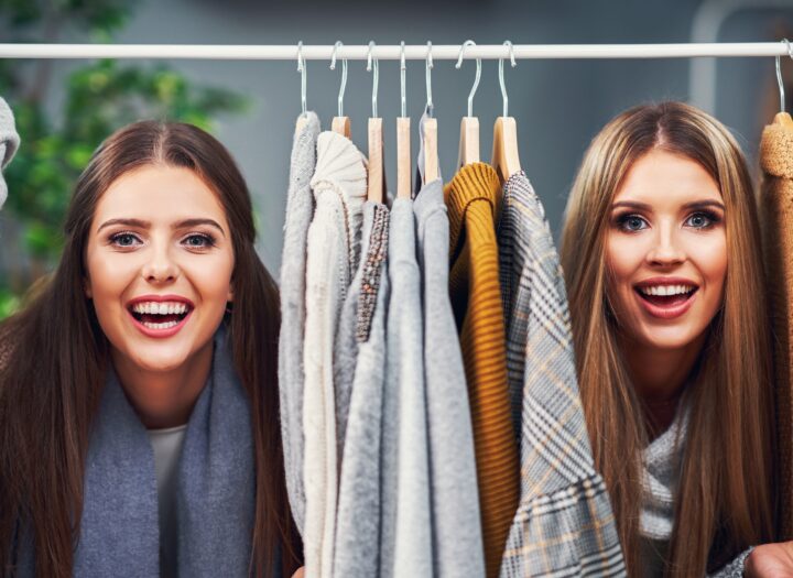 Adult women shopping for clothes in boutique in autumn