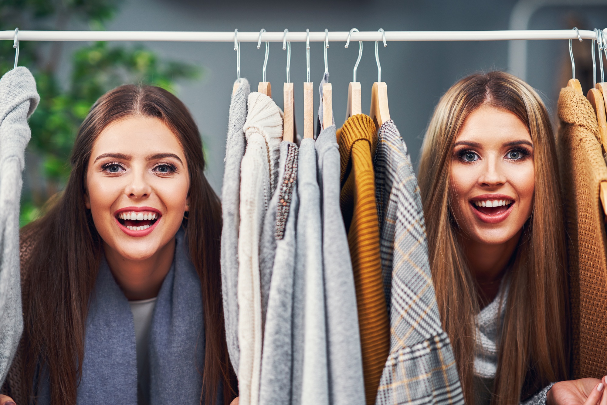 Adult women shopping for clothes in boutique in autumn